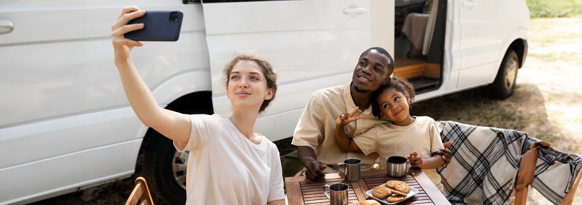 A family laughing together and enjoying a sunny day at their RV site at Texas Lakes Ranch RV Park in Aubrey, TX. 